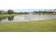 Scenic pond view with a fountain and lush green lawn in a quiet, upscale residential community at 2569 Laurel Glen Dr, Lakeland, FL 33803