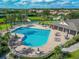 Community pool area featuring a lap pool, lounge chairs, and a clubhouse for residents at 2569 Laurel Glen Dr, Lakeland, FL 33803