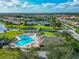 Aerial shot of a community pool and tennis courts surrounded by beautifully maintained landscaping at 2569 Laurel Glen Dr, Lakeland, FL 33803