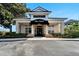 Charming Pro Shop building with a black awning and well-maintained landscaping. Sign says 1600 at 2569 Laurel Glen Dr, Lakeland, FL 33803