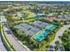 An aerial view of tennis courts and pickleball courts in a community setting at 2569 Laurel Glen Dr, Lakeland, FL 33803