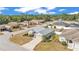 Aerial view of a well-maintained home with lush landscaping in a quiet residential neighborhood, featuring a grey roof at 2700 Oak Hammock Loop, Mulberry, FL 33860
