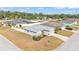 Aerial view of a well-maintained home with lush landscaping in a quiet residential neighborhood, featuring a grey roof at 2700 Oak Hammock Loop, Mulberry, FL 33860