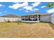 A spacious backyard features a screened lanai, a fire pit, and well-maintained landscaping providing a serene outdoor space at 2700 Oak Hammock Loop, Mulberry, FL 33860