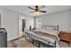 Cozy bedroom with a ceiling fan, and a black metal bed frame, providing a comfortable retreat at 2700 Oak Hammock Loop, Mulberry, FL 33860