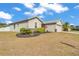 Well-manicured front yard with a landscaped garden bed, enhancing the home's welcoming exterior at 2700 Oak Hammock Loop, Mulberry, FL 33860
