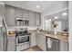 Well-equipped kitchen with granite countertops, stainless steel appliances, and ample cabinet space at 2700 Oak Hammock Loop, Mulberry, FL 33860