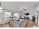 Inviting living room boasts natural light, ceiling fan, and views of the patio through sliding glass doors at 2700 Oak Hammock Loop, Mulberry, FL 33860