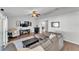 Comfortable living room features hardwood floors, ceiling fan, and neutral tones for a relaxing atmosphere at 2700 Oak Hammock Loop, Mulberry, FL 33860