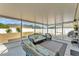 Relaxing screened-in patio with comfortable wicker furniture, great for enjoying the outdoors at 2700 Oak Hammock Loop, Mulberry, FL 33860