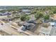 Aerial shot of a home in a neighborhood with mature trees, a pool, and privacy fence at 2705 N Martha Ave, Lakeland, FL 33805