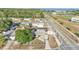 Aerial view of a green house with mature trees on a sunny day at 2705 N Martha Ave, Lakeland, FL 33805