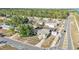 Aerial view of a green house with mature trees in a quiet neighborhood at 2705 N Martha Ave, Lakeland, FL 33805