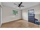 Simple bedroom featuring a ceiling fan, wood floors, natural light from two windows and a storage chest at 2705 N Martha Ave, Lakeland, FL 33805