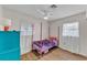 Charming bedroom with pink canopy bed, hardwood floors, and lots of natural light at 2705 N Martha Ave, Lakeland, FL 33805