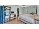 Spacious bedroom with a queen bed, wood-style floors, shelving, and access to an organized closet at 2705 N Martha Ave, Lakeland, FL 33805