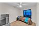 Simple bedroom with neutral colors, a ceiling fan, and a blue curtain at 2705 N Martha Ave, Lakeland, FL 33805