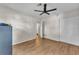 A bright bedroom with hardwood floors, a ceiling fan, and a closet at 2705 N Martha Ave, Lakeland, FL 33805