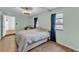 Bright bedroom with wood floors, neutral walls, dark blue curtains and a sewing machine desk at 2705 N Martha Ave, Lakeland, FL 33805