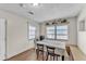 Inviting dining area with a window, neutral walls, light wood floors and a white exterior door at 2705 N Martha Ave, Lakeland, FL 33805