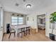 Cozy dining room with wood floors, an adjacent bedroom, and plants lining the light-filled window at 2705 N Martha Ave, Lakeland, FL 33805