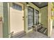 Inviting front porch with seating next to the leaded glass front door at 2705 N Martha Ave, Lakeland, FL 33805
