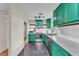 Bright kitchen with green cabinets, stainless steel appliances, and marble countertops at 2705 N Martha Ave, Lakeland, FL 33805