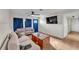 Bright living room with wood floors, comfortable seating, and a blue front door with updated wainscotting at 2705 N Martha Ave, Lakeland, FL 33805