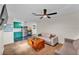 Cozy living room featuring wood floors, modern ceiling fan and comfortable seating near an updated kitchen at 2705 N Martha Ave, Lakeland, FL 33805