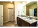 Bathroom featuring granite countertops, a large mirror, and double sinks at 297 Spirit Landings Cir, Winter Haven, FL 33880