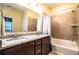 Bathroom showcasing a tub, granite countertops, and double sinks at 297 Spirit Landings Cir, Winter Haven, FL 33880