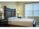 Relaxing bedroom with a large bed, side tables, curtains, and tile flooring at 297 Spirit Landings Cir, Winter Haven, FL 33880