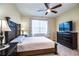 Comfortable bedroom featuring a ceiling fan, tile floors, and stylish furniture at 297 Spirit Landings Cir, Winter Haven, FL 33880