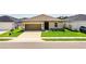 Charming single-story home featuring a well-manicured lawn and a two-car garage at 297 Spirit Landings Cir, Winter Haven, FL 33880