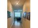 Bright hallway with decorative art leading to a living space with a fan and window at 297 Spirit Landings Cir, Winter Haven, FL 33880