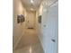 Inviting hallway featuring tile flooring, neutral walls, and white doors with hardware at 297 Spirit Landings Cir, Winter Haven, FL 33880