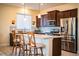 Modern kitchen with stainless steel appliances, granite counters, and breakfast bar seating at 297 Spirit Landings Cir, Winter Haven, FL 33880