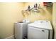 Laundry Room featuring a washer, dryer, and metal shelving at 297 Spirit Landings Cir, Winter Haven, FL 33880