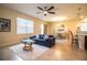 Bright living room boasts tile flooring, contemporary furnishings, and an open floor plan at 297 Spirit Landings Cir, Winter Haven, FL 33880