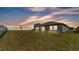 Spacious backyard featuring a well-maintained lawn, privacy fence, and appealing exterior architecture at 2991 Flying Blackbird Rd, Bartow, FL 33830