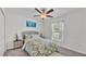 Bright bedroom with a ceiling fan, white walls, carpet, and a stylish bed and furnishings at 2991 Flying Blackbird Rd, Bartow, FL 33830