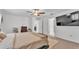 Bright bedroom features a bed, mounted TV, and access to closets and ensuite bathroom at 2991 Flying Blackbird Rd, Bartow, FL 33830