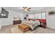 Bright bedroom with a ceiling fan, white walls, carpet, and a stylish bed and furnishings at 2991 Flying Blackbird Rd, Bartow, FL 33830