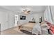 Bright bedroom featuring a bed, mounted TV, modern furnishings, and a glimpse into the ensuite bathroom at 2991 Flying Blackbird Rd, Bartow, FL 33830
