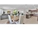 Open-concept dining area with modern furnishings and seamless connection to the living room and kitchen at 2991 Flying Blackbird Rd, Bartow, FL 33830