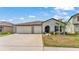Well-maintained single-story home features a 2-car garage, manicured lawn, and inviting entryway at 2991 Flying Blackbird Rd, Bartow, FL 33830