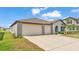 Charming single-story home boasts a 2-car garage, well-maintained lawn, and inviting entryway at 2991 Flying Blackbird Rd, Bartow, FL 33830
