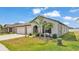 Charming single-story home features a 2-car garage, manicured lawn, and inviting entryway framed by lush landscaping at 2991 Flying Blackbird Rd, Bartow, FL 33830