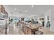 Open-concept kitchen with granite counters and a large island, seamlessly flowing into the dining and living areas at 2991 Flying Blackbird Rd, Bartow, FL 33830