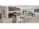 Modern kitchen features dark cabinetry, granite countertops, stainless steel appliances, and a spacious island with seating at 2991 Flying Blackbird Rd, Bartow, FL 33830